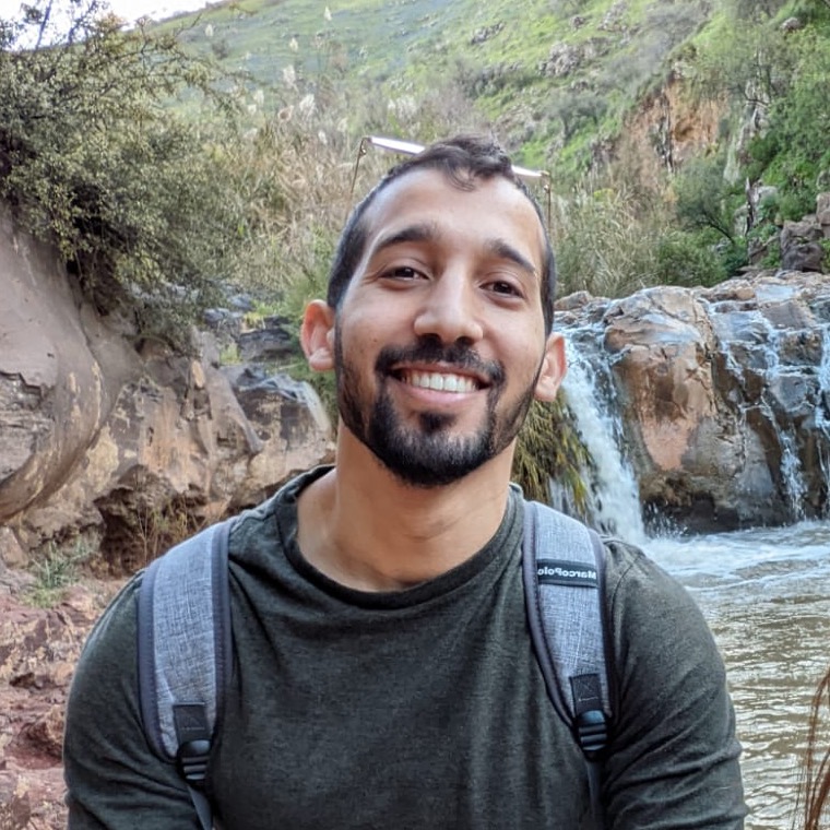 Sage Ahrac outdoors near a waterfall